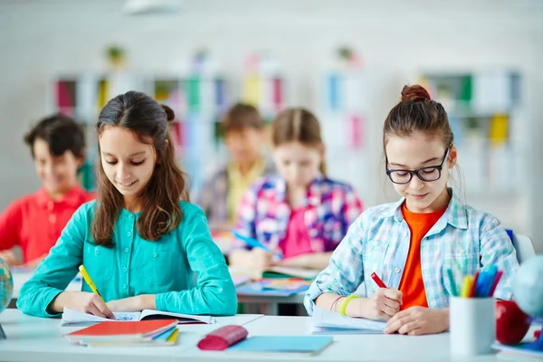 Schoolchildren writing during lesson