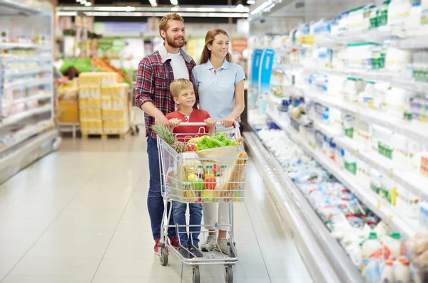 Parents and son buying food