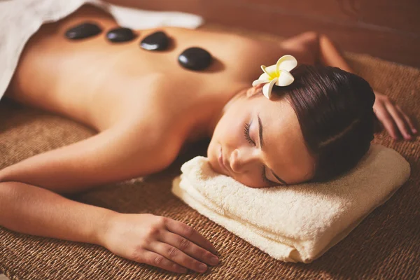 Young female lying in spa salon