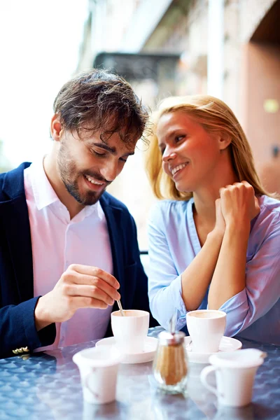 Affectionate couple having coffee in cafe