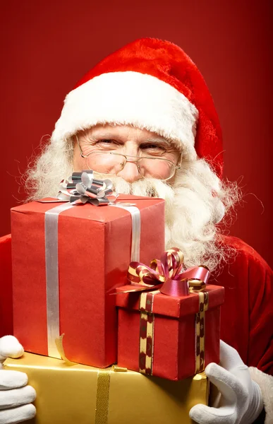 Santa Claus with pile of gifts
