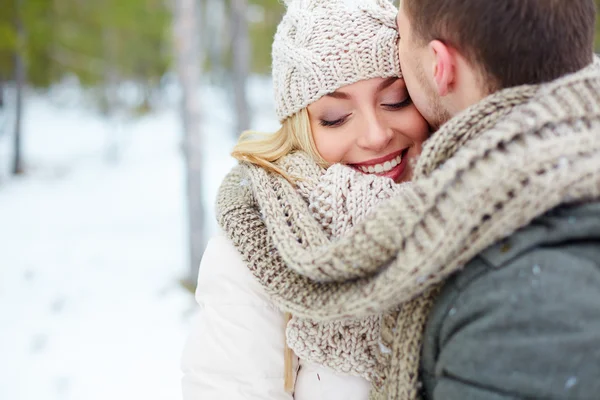 Man kissing woman in winter