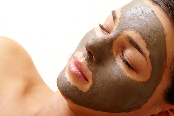 Woman with clay mask on face