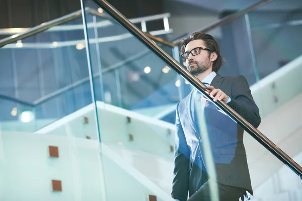 Mature businessman going upstairs