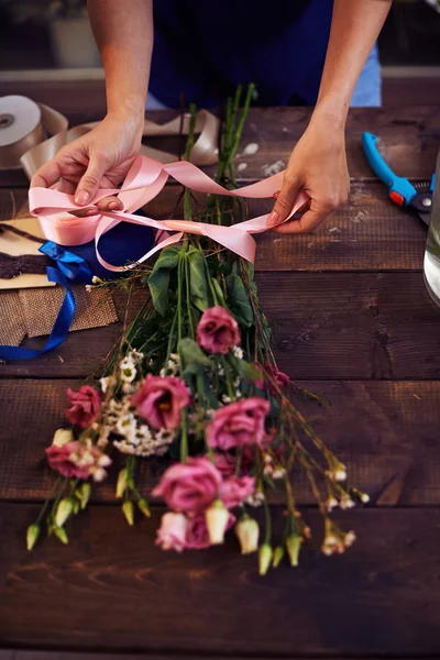 Female hands making a bouquet