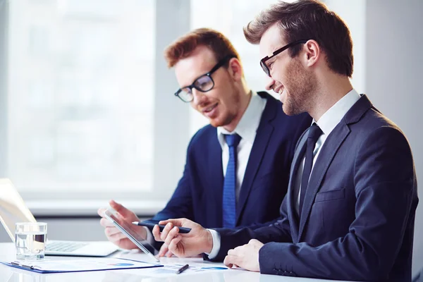 Businessmen learning data on touchpad