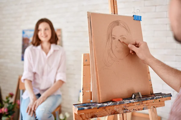 Artist drawing young woman