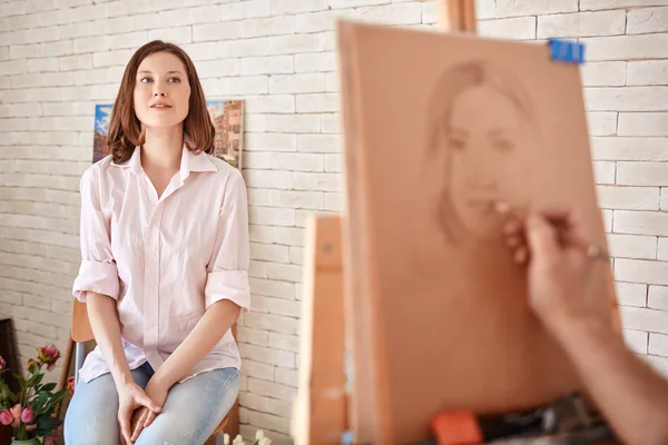 Artist drawing young woman