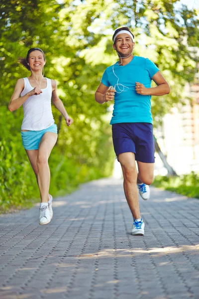 Man and woman running in park