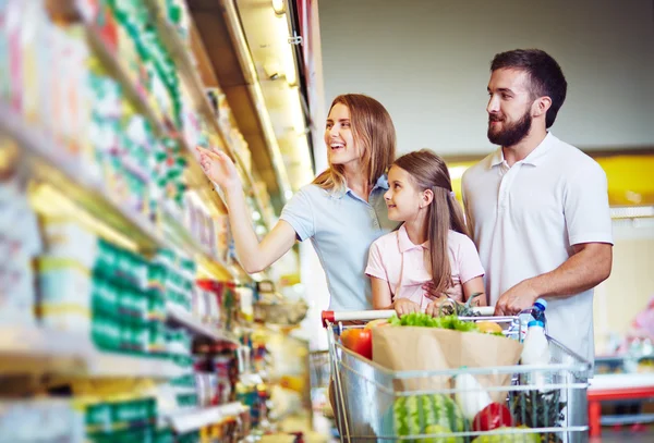 Young family choosing products