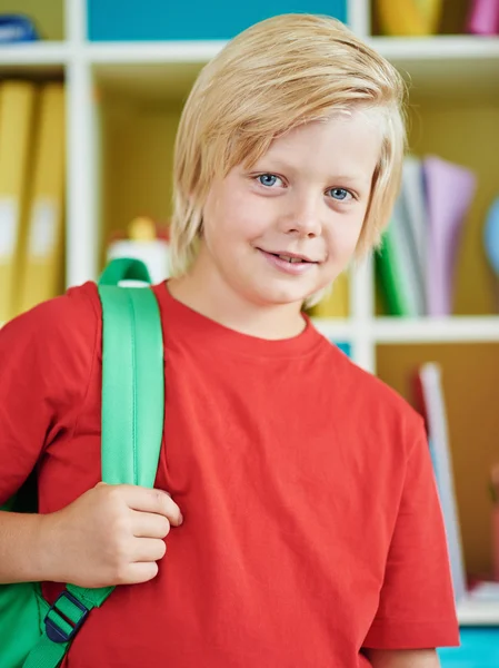 Happy pupil with backpack