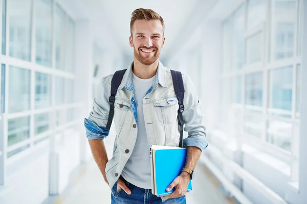 Handsome student with book and touchpad