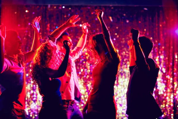 Young people dancing in the night club