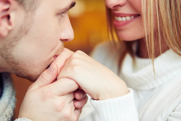 Guy kissing hand of his girlfriend