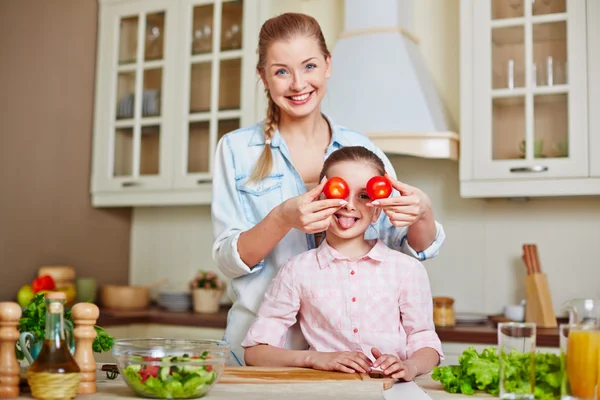 Woman with  daughter and tomatoes