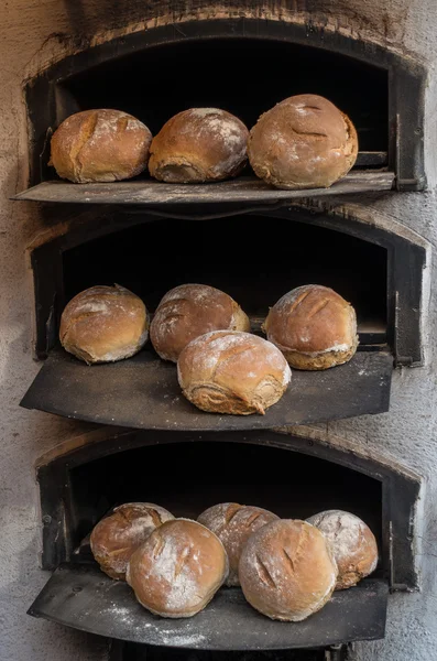 Freshly baked bread in a wood-fired stone oven