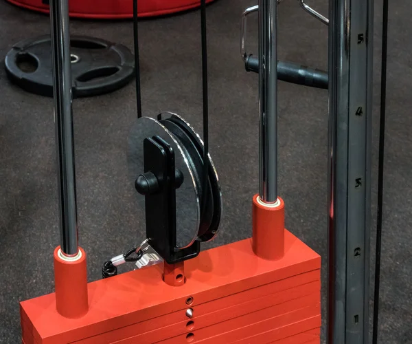 Weight machine with cable and plate weight in fitness center