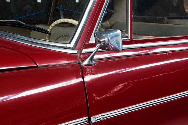 Part of the old red car and car mirror