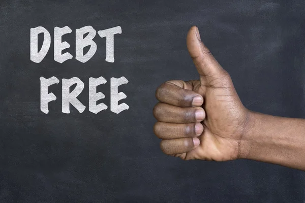 Male hand giving the thumbs up gesture to the phrase Debt Free written on a blackboard