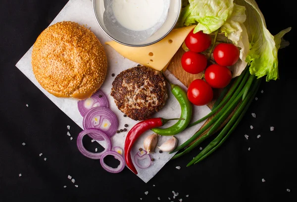 Ingredients for hamburger on a dark background. Top view.