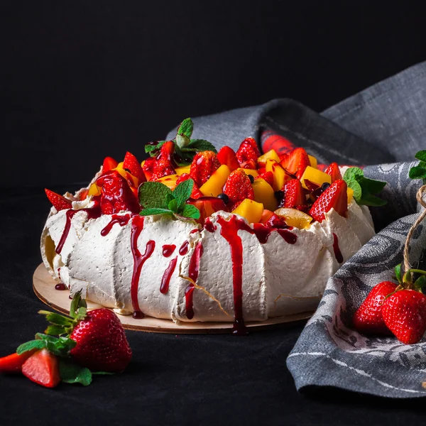 Pavlova cake on dark background.