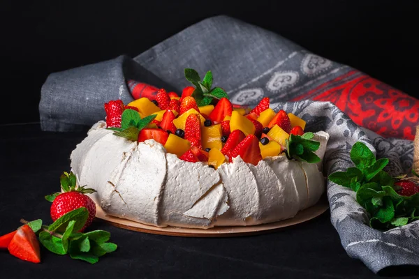 Pavlova cake on dark background.