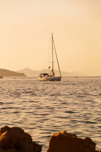 Boat in the sea near the rocky shore. Dubrovnik, Croatia