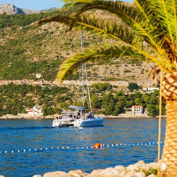 Boat in the sea near the rocky shore. Dubrovnik, Croatia