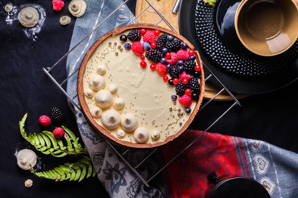 White chocolate mousse cake on a dark background.