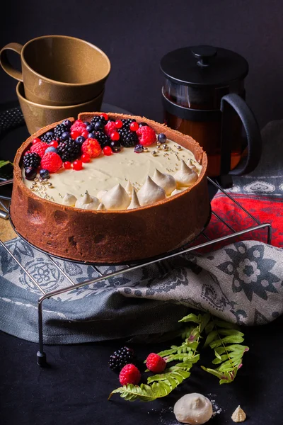 White chocolate mousse cake on a dark background.