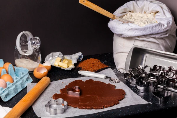 The process of baking chocolate cake base from shortcrust pastry.