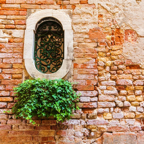 Fragment of red vintage old brick wall with round window.