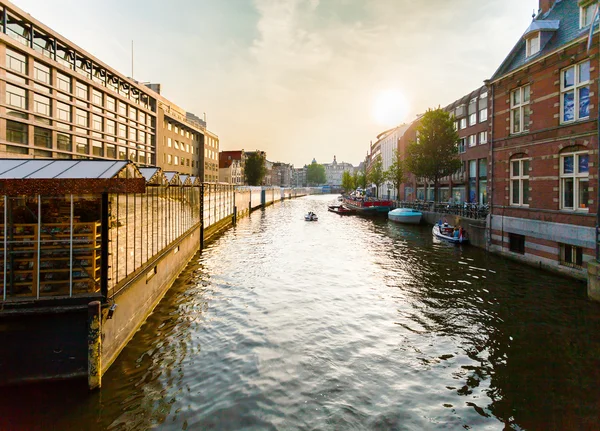 Typical Dutch canal located behind the flower market in Amsterdam.