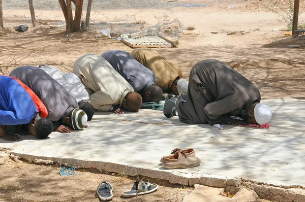 Muslims praying in congregation outside, islamic Prayer