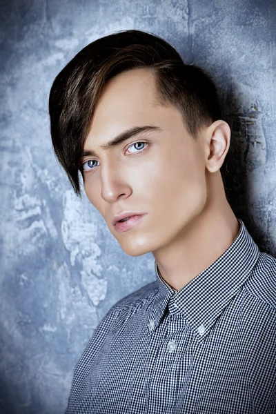 Male hairstyle. Fashion male model with stylish upright hair.