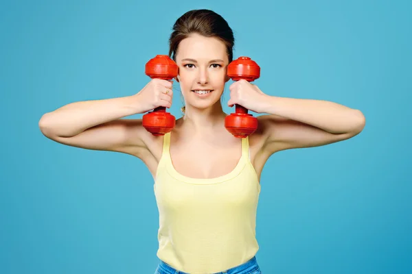 Like sports, athletic young woman with dumbbells.