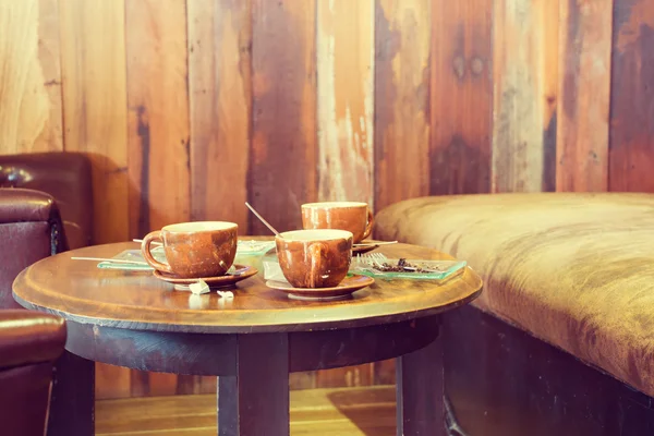 Cup of coffee on the table in coffee shop. (Vintage Process)