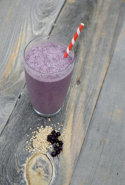 Blueberry and steel cut oats smoothie on a wooden background