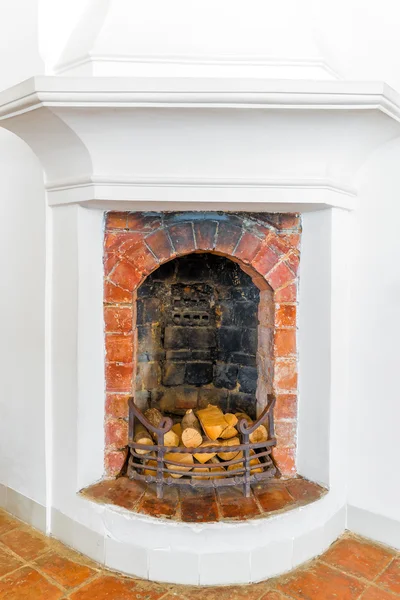 Brick fireplace with firewood in the house