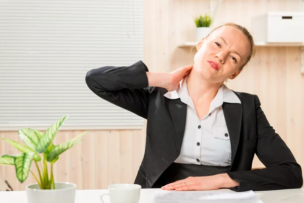 Business woman frustrated her sick neck, portrait in an office