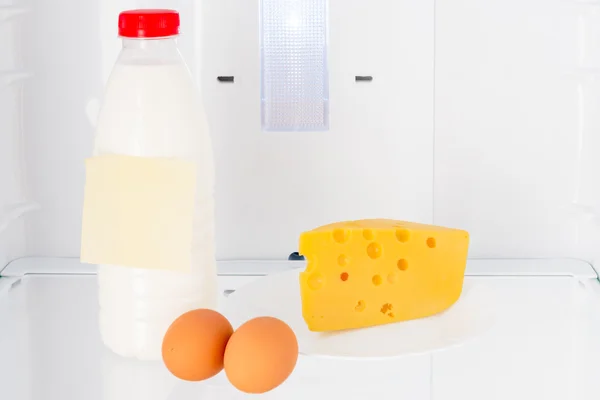 Dairy products and eggs on the shelf of the refrigerator