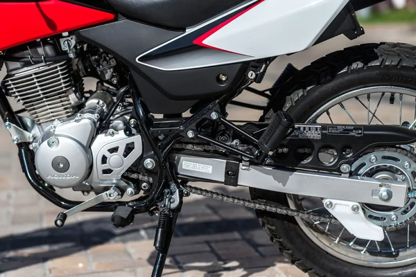 Kyiv, Ukraine - July 7th, 2015: Red motorcycle Honda XR 150L at the city street.