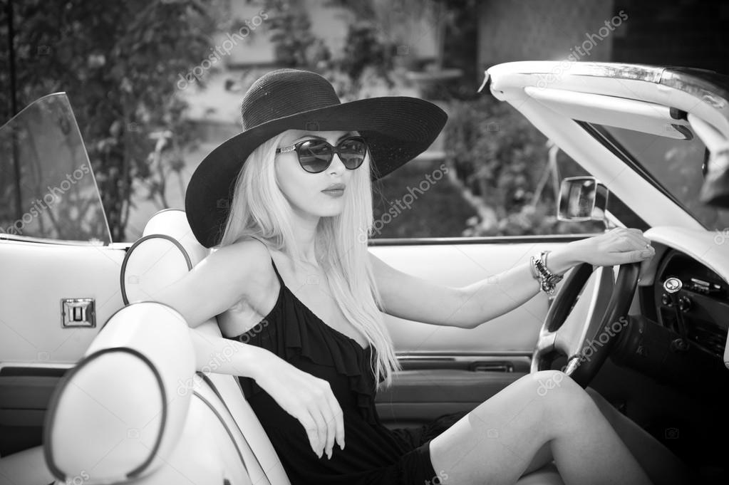 depositphotos_53734723-Outdoor-summer-portrait-of-stylish-blonde-vintage-woman-driving-a-convertible-retro-car.-Fashionable-attractive-fair-hair-female-with-black-hat-in-withe-leather-vehicle.-Black-and-white-outdoors-shot..jpg