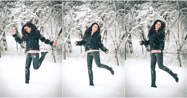 Attractive brunette girl in black posing playing in winter scenery. Beautiful young woman with long hair enjoying the snow. Long legs young woman jumping laughing in wintertime outdoor