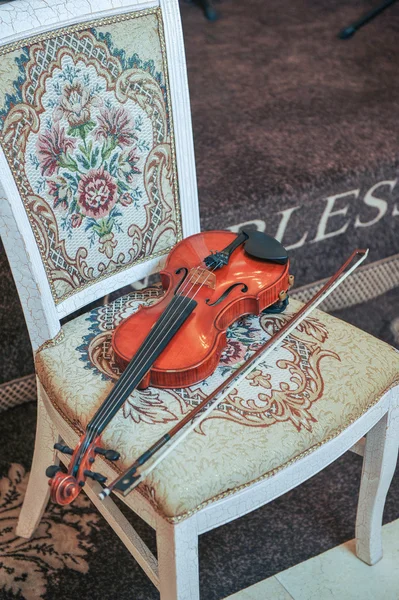 Classic music violin vintage close up. Violin on chair