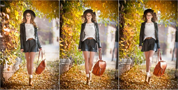 Attractive young woman in an autumnal shot outdoors. Beautiful fashionable school girl with leather backpack posing in park. Elegant college student with glasses, hat and short skirt in fall scenery .