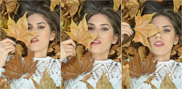 Nice girl covered with autumnal leaves. Young woman laying down on the ground covered by fall foliage in park. Beautiful sexy girl lying on autumn leaves. Young woman covered with golden autumn leaves