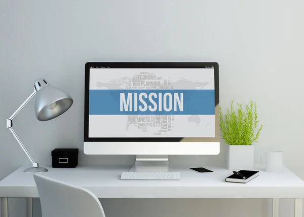 Modern workspace with mission text on screen