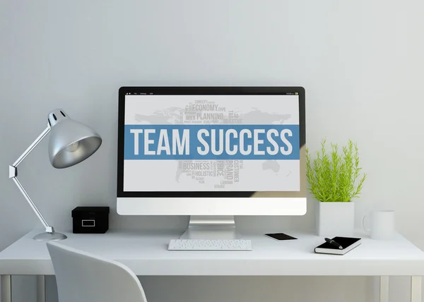 Modern workspace with team success on screen