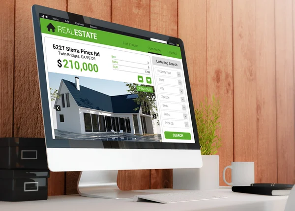 Workspace with real estate website on screen